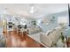 Bright living room featuring hardwood floors, stylish furniture, and an open layout at 893 Fenwick Loop, The Villages, FL 32163