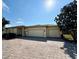 House exterior featuring a three-car garage and paved driveway at 917 Shorehaven Dr, Poinciana, FL 34759