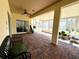 Spacious screened porch with brick flooring and seating at 917 Shorehaven Dr, Poinciana, FL 34759