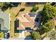 Aerial view of a charming home, featuring a brown roof and lush green surroundings with solar panels at 9184 Se 135Th St, Summerfield, FL 34491