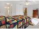 Bright bedroom with en suite access and a colorful quilt at 9184 Se 135Th St, Summerfield, FL 34491