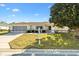 Charming single-story home with a well-manicured front yard and cozy exterior lighting at 9184 Se 135Th St, Summerfield, FL 34491