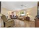 Spacious living room featuring tile flooring, a ceiling fan, and comfortable seating at 9184 Se 135Th St, Summerfield, FL 34491