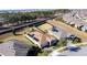 Aerial view of homes with solar panels and a tree line at 96 Silver Maple Rd, Groveland, FL 34736