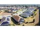 Aerial view of houses with solar panels and a community at 96 Silver Maple Rd, Groveland, FL 34736