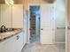 Bathroom with granite countertop, linen closet, and tile floors at 96 Silver Maple Rd, Groveland, FL 34736