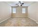 Well-lit bedroom with tile flooring and ceiling fan at 96 Silver Maple Rd, Groveland, FL 34736