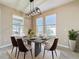 Modern dining room with concrete table, pendant lighting, and a view of the backyard at 96 Silver Maple Rd, Groveland, FL 34736