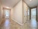 Bright entryway with tile flooring, leading to laundry and other rooms at 96 Silver Maple Rd, Groveland, FL 34736