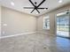 Spacious Gathering room with tile flooring and a view of the backyard at 96 Silver Maple Rd, Groveland, FL 34736