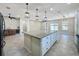 Large kitchen island with granite countertops and white cabinets at 96 Silver Maple Rd, Groveland, FL 34736