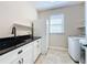 White cabinetry and granite countertop in laundry room at 96 Silver Maple Rd, Groveland, FL 34736