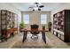 Home office with built-in shelving and hardwood desk at 96 Silver Maple Rd, Groveland, FL 34736