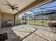 Relaxing screened patio with built-in grill and ceiling fan at 96 Silver Maple Rd, Groveland, FL 34736