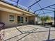 Outdoor patio with screened enclosure, pavers, and grill at 96 Silver Maple Rd, Groveland, FL 34736