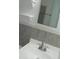 Clean bathroom with gray tile and a white vanity at 703 Sullivan Ave, Ocoee, FL 34761