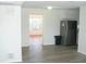 Open dining area with gray vinyl flooring and view into sunroom at 703 Sullivan Ave, Ocoee, FL 34761