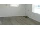 Bright living room with gray vinyl flooring and neutral walls at 703 Sullivan Ave, Ocoee, FL 34761