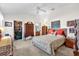 Main bedroom with a queen bed, ample furniture, and backyard access at 3001 Saint Thomas Ln, The Villages, FL 32162