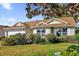 One-story house with a brown roof, beige siding, and well-manicured lawn at 3001 Saint Thomas Ln, The Villages, FL 32162