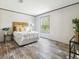 Main bedroom with wood-look floors and a rustic wooden headboard at 00 Mark Ave, Lady Lake, FL 32159