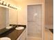 Bathroom featuring a marble tiled shower and a vanity with black countertop and modern lighting at 1001 Willa Lake Cir, Oviedo, FL 32765