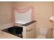 Bathroom view highlighting a jacuzzi tub with a pink curtained window, and a toilet at 1001 Willa Lake Cir, Oviedo, FL 32765