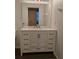 Bright bathroom featuring a vanity with white cabinets, a marble countertop, and a large mirror at 1001 Willa Lake Cir, Oviedo, FL 32765