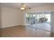 Living room featuring ceiling fan and sliding glass doors leading to outdoor pool area at 1001 Willa Lake Cir, Oviedo, FL 32765