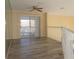 Living room showcasing hardwood floors, sliding glass doors to the exterior, ceiling fan, and white trim at 1001 Willa Lake Cir, Oviedo, FL 32765