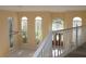 Living room features many windows providing light and railing overlooking the front door at 1001 Willa Lake Cir, Oviedo, FL 32765