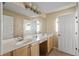 Bathroom with double sinks and light wood cabinets at 10962 Willow Ridge Loop, Orlando, FL 32825