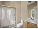 Clean bathroom with shower, toilet and wooden vanity at 10962 Willow Ridge Loop, Orlando, FL 32825