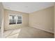 Simple bedroom with carpeted floors and a large window at 10962 Willow Ridge Loop, Orlando, FL 32825