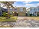 Two-story house with a two-car garage and landscaped front yard at 10962 Willow Ridge Loop, Orlando, FL 32825