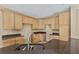 Kitchen with dark countertops and light wood cabinets at 10962 Willow Ridge Loop, Orlando, FL 32825