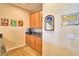 Elegant bar area with custom cabinetry, granite countertops and stylish decor at 113 Pecorri Ct, Auburndale, FL 33823