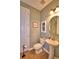 Small half bathroom with tile floor, toilet and pedestal sink at 113 Pecorri Ct, Auburndale, FL 33823