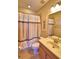 Clean bathroom with seashell shower curtain and tile floor at 113 Pecorri Ct, Auburndale, FL 33823