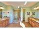 Luxurious bathroom with double vanity, large mirrors and a walk-in tiled shower at 113 Pecorri Ct, Auburndale, FL 33823