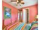 Bedroom with wood bed frame and colorful bedding at 113 Pecorri Ct, Auburndale, FL 33823
