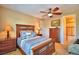 Bright bedroom with wood furniture and en-suite bath at 113 Pecorri Ct, Auburndale, FL 33823