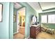 Bright bedroom featuring a large dresser and view to a full ensuite bathroom at 113 Pecorri Ct, Auburndale, FL 33823