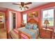 Bedroom with wood bed frame and colorful bedding at 113 Pecorri Ct, Auburndale, FL 33823