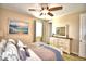 Bedroom with dresser, ceiling fan, and large window at 113 Pecorri Ct, Auburndale, FL 33823