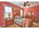 Bedroom with a wood bed frame and colorful bedding at 113 Pecorri Ct, Auburndale, FL 33823