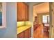 Butlers pantry with granite counters connecting to the dining room at 113 Pecorri Ct, Auburndale, FL 33823