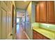 Butlers pantry with granite countertop and wood cabinets at 113 Pecorri Ct, Auburndale, FL 33823