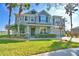 Two story house with palm trees and landscaped yard at 113 Pecorri Ct, Auburndale, FL 33823