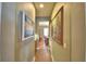 Bright hallway with hardwood floors and artwork at 113 Pecorri Ct, Auburndale, FL 33823